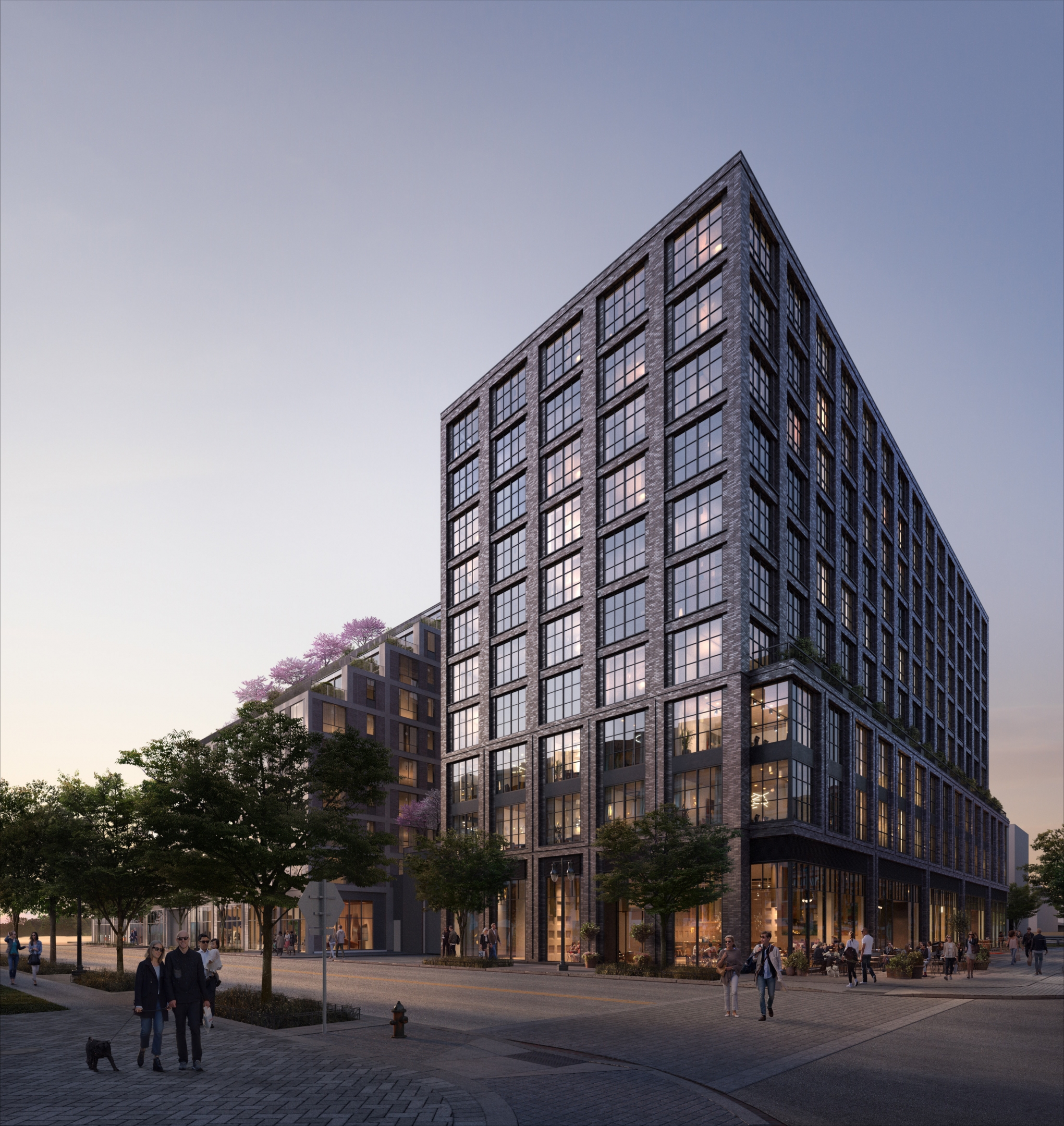 Architectural visualization of Parcel for Studios. A image of an office building from a street view at dusk.